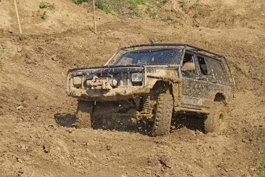 Off-road vehicle in muddy terrain. All potential trademarks are removed.