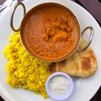 Chicken curry served with rice and naan