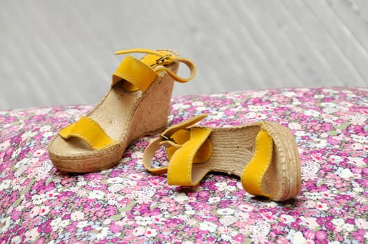 A pair of women espadrilles, high heeled and yellow suede
