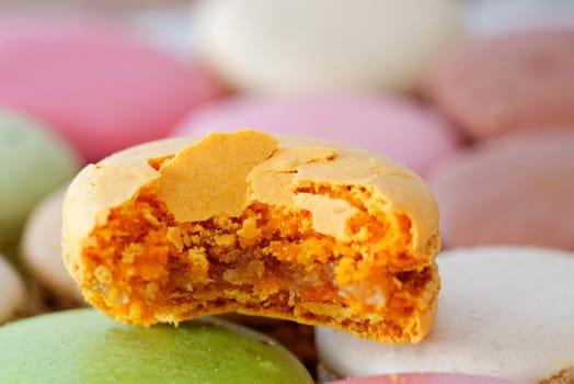 A bitten ginger bread macaron