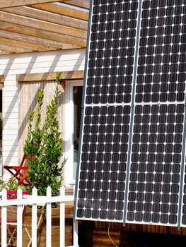 A wooden house with solar panel, sustainable development concept
