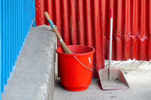 Red plastic bucket, broom and scoop