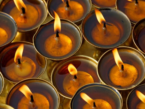 Butter lamps in a buddhist monastery in Kathmandu, Nepal