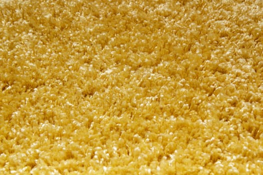yellow carpet of artificial material close-up. The texture of the carpet