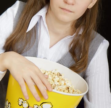 girl with popcorn on a black background