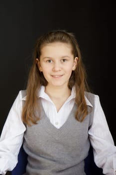 portrait of a girl with a white blouse and a gray vest