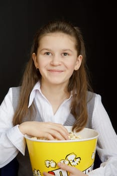 girl with popcorn on a black background