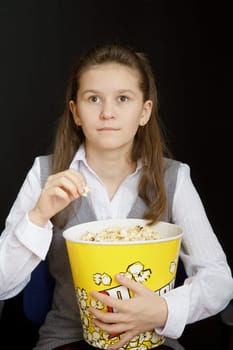 girl with popcorn on a black background