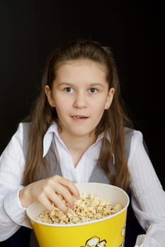 surprised girl with popcorn on a black background