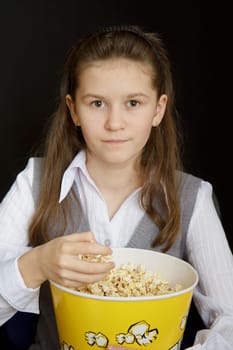 girl with popcorn on a black background