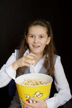 emotional girl with popcorn on a black background