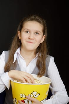 girl with popcorn on a black background
