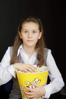 girl with popcorn on a black background
