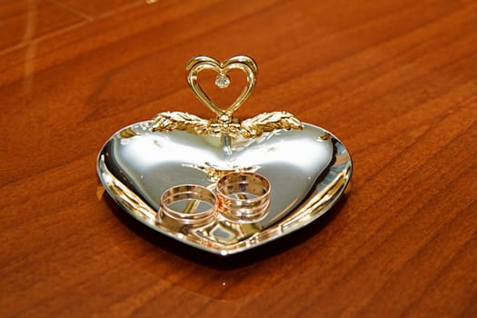wedding rings to the registration wooden desk