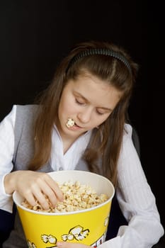 girl asleep in a movie theater with popcorn