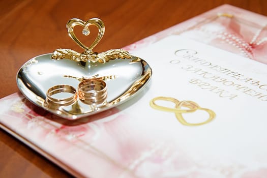 wedding rings and marriage certificate to the registration desk
