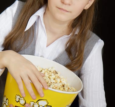 girl with popcorn on a black background