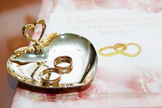 wedding rings and marriage certificate to the registration desk