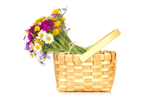 Wicker basket with a bouquet of wildflowers. Isolated on white background.