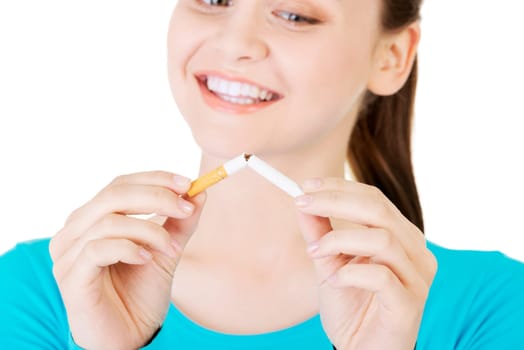 young woman with broken cigarette. stop smoking concept.