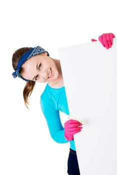 smiling happy cleaning woman showing blank sign board.