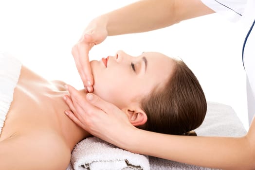 beautiful young woman enjoys massage at saloon spa