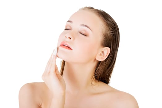 portrait of happy young woman cleaning skin by cotton pad,over white background
