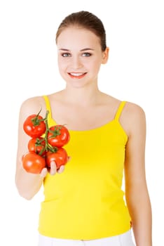 young happy woman with a bunch of tomatoes. isolated on white.