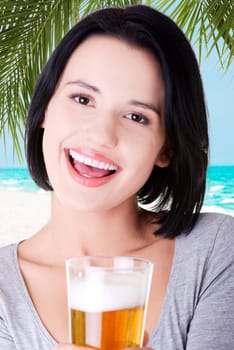beautiful happy woman with a glass of beer