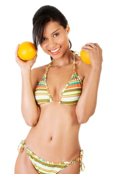 happy summer woman in bikini with oranges. isolated on white