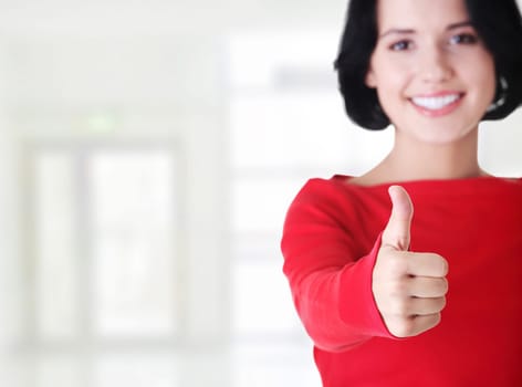 beautiful young woman showing thumbs up sign
