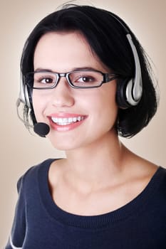 closeup of attractive customer support representative smiling with headset on brown background