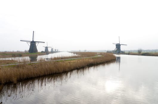 typical dutch windmills at Kinderdijk, Netherlands. A system of 19 windmills was built around 1740 to drain the polder. This group of mills is the largest concentration of old windmills in the Netherlands. The windmills of Kinderdijk are one of the best known Dutch tourist sites. They have been a UNESCO World Heritage Site since 1997.