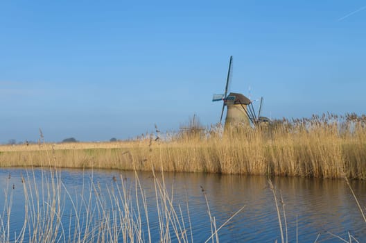Dutch windmills in Kinderdijk, Netherlands. The windmills of Kinderdijk are one of the best known Dutch tourist sites. They have been a UNESCO World Heritage Site since 1997.