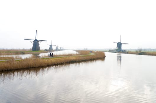 typical dutch windmills at Kinderdijk, Netherlands. A system of 19 windmills was built around 1740 to drain the polder. This group of mills is the largest concentration of old windmills in the Netherlands. The windmills of Kinderdijk are one of the best known Dutch tourist sites. They have been a UNESCO World Heritage Site since 1997.