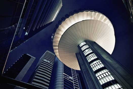 Modern futuristic office buildings exteriors at night.