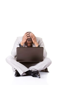 Stressed businessman working on laptop, isolated on white