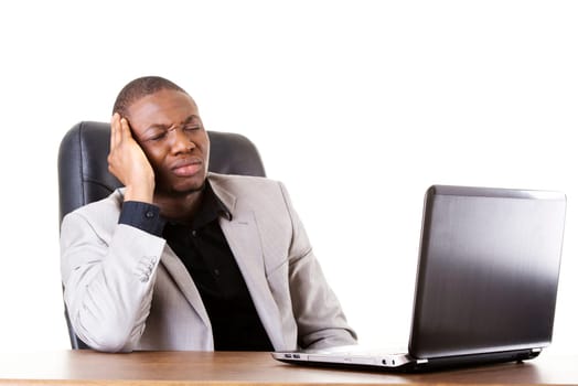 Stressed businessman working on laptop, isolated on white