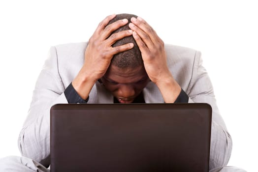 Stressed businessman working on laptop, isolated on white