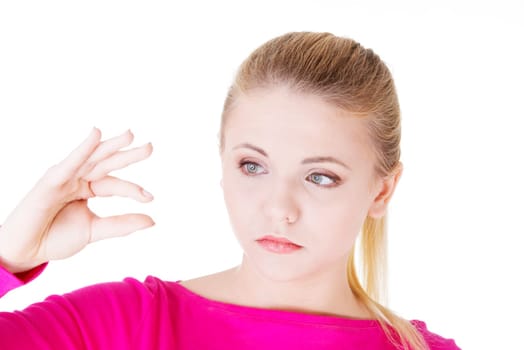 Woman showing something small, isolated on white