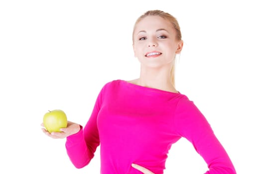 Young woman holding green fresh apple in hand, isolated over white background