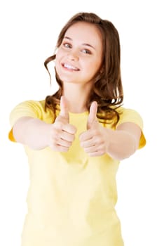 Beautiful teen woman in casual clothes gesturing thumbs up. Isolated