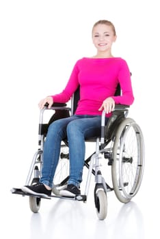 Attractive smiling disabled woman sitting in a wheel chair isolated on white