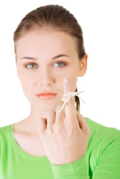 Woman trying to remember what the piece of string round her finger was meant to remind her of, isolated on white background.
