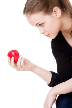 Pretty woman in depression holding small heart in her hand.