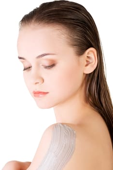 Beautiful face of spa woman with healthy clean skin and clay mask on arm. Isolated on white.