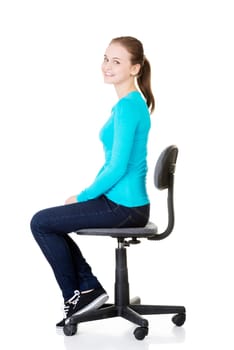 Young happy student woman or businesswoman sitting on a wheel chair, isolated over a white background