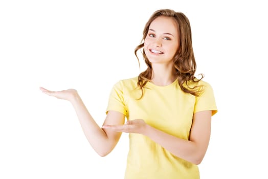Happy , excited young woman presenting copy space on her palm, isolated on white