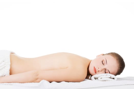 Beauty young woman relaxing in spa. Isolated on white.