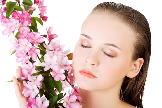 Beautiful face of spa woman with healthy clean skin and pink flowers. Isolated on white.